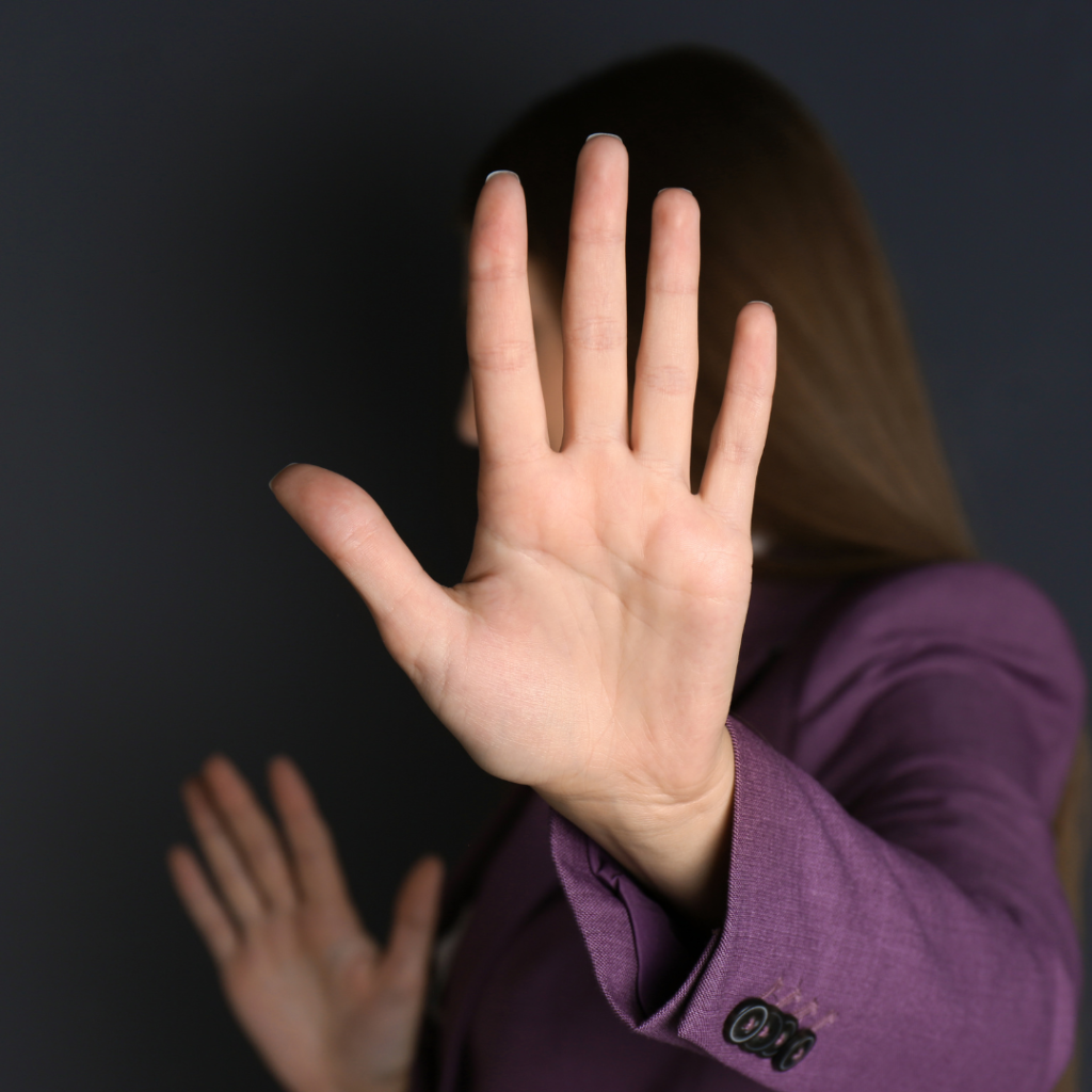 Woman with her hands in front of her face.