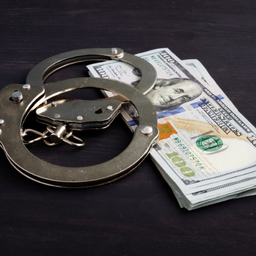 Handcuffs and cash on table. Bail in a Massachusetts criminal case.