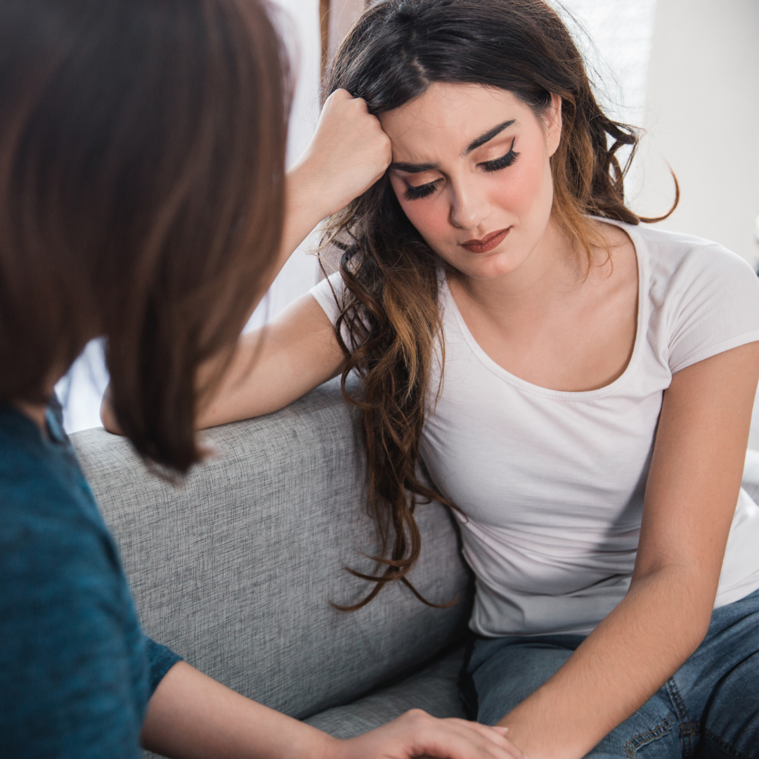 Woman talking to friend about harassment in Massachusetts.