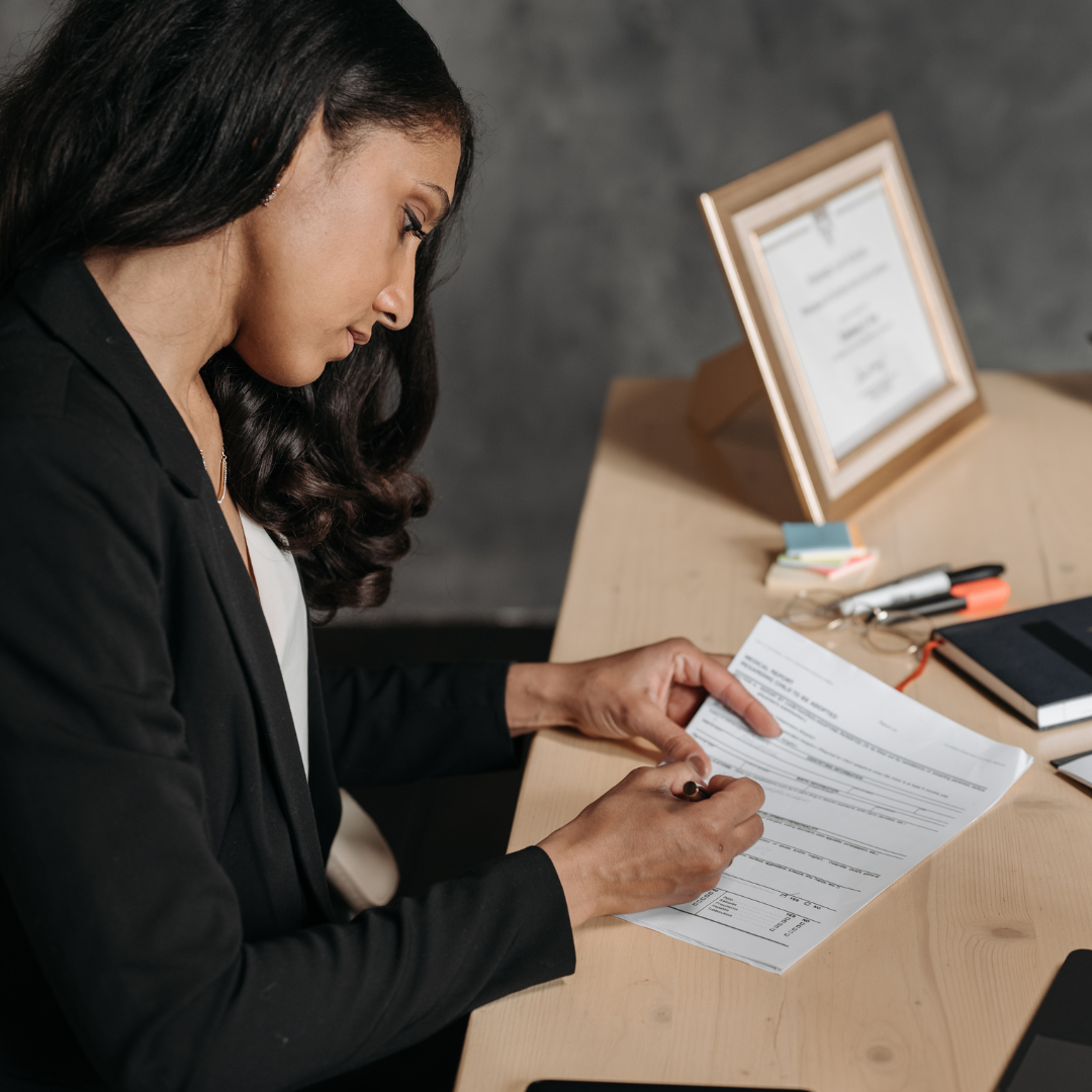Woman signing Massachusetts restraining order application.