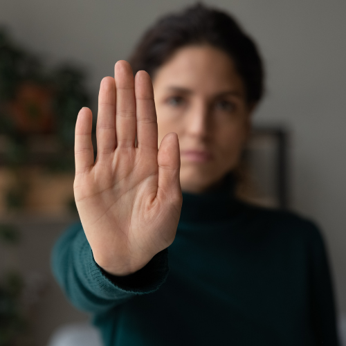 Woman with her hand up stopping harassment in Massachusetts.