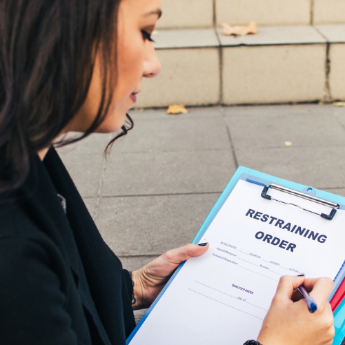 Woman filling out Massachusetts Restraining Order application.