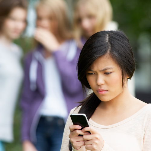 Woman reading harassing text messages in Massachusetts.