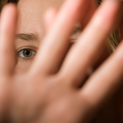 Woman holding her her hand up to keep her abuser away in Massachusetts.