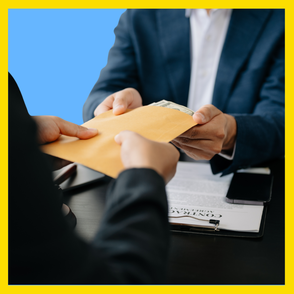Man handing envelope of money to an embezzler in Massachusetts.