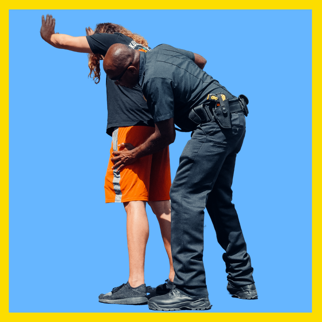 Cop frisking man suspected of possessing illegal items in Massachusetts.