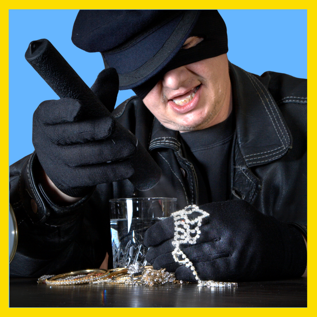 Man in ski mask holding stolen jewelry.