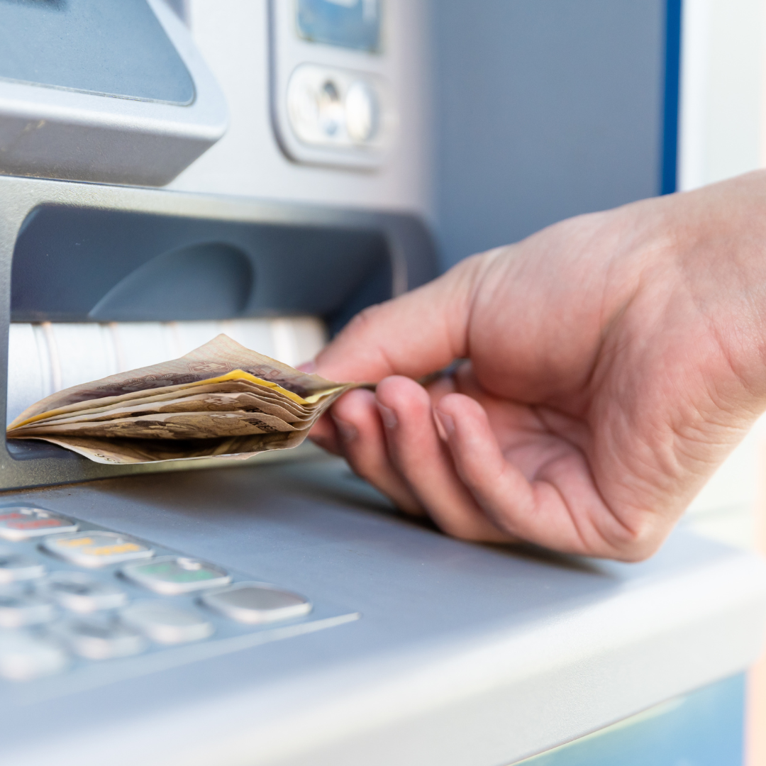 Man withdrawing money from an ATM before divorce in Massachusetts