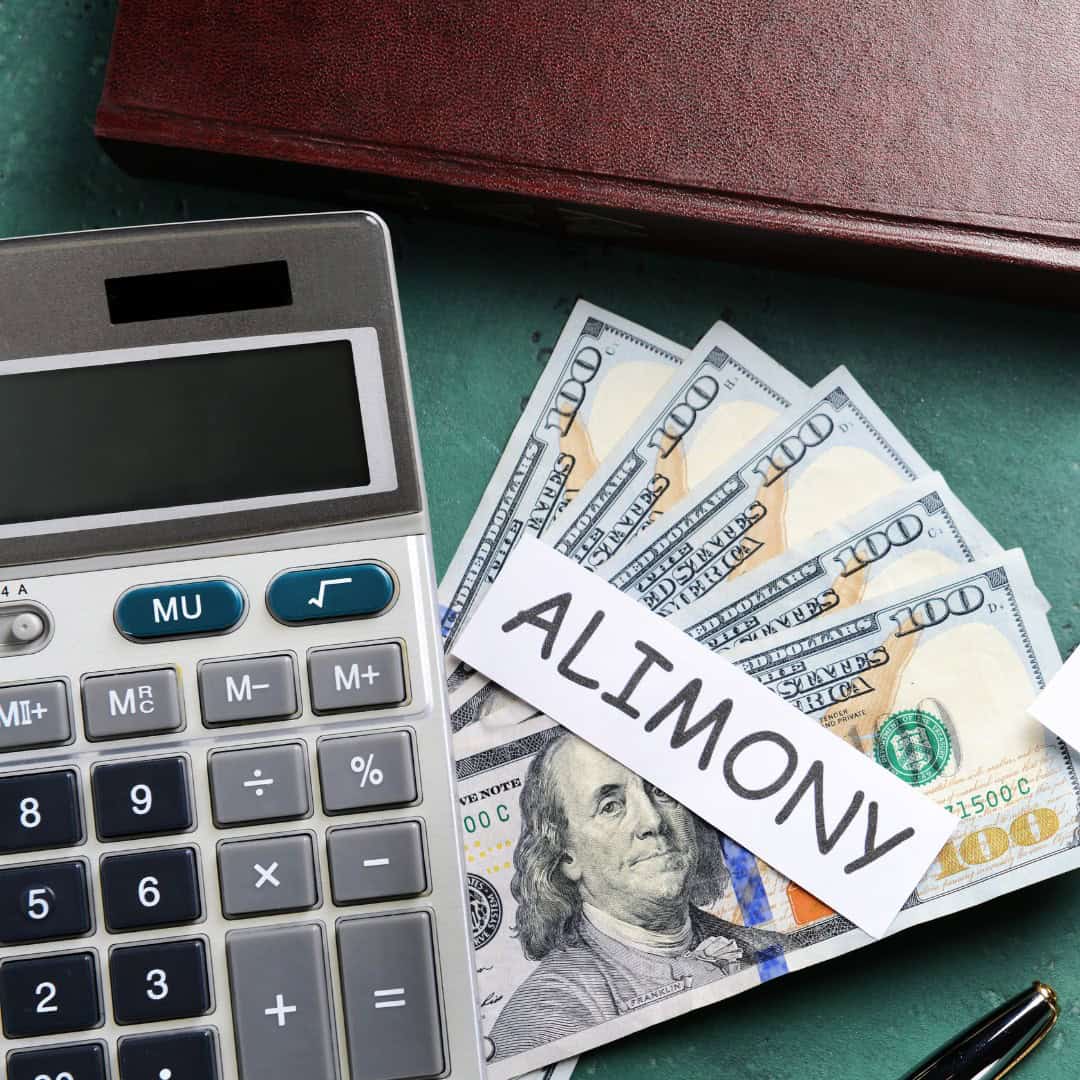 Massachusetts legal services - Financial documents and a calculator with a sign reading "ALIMONY" on a desk, related to family law.
