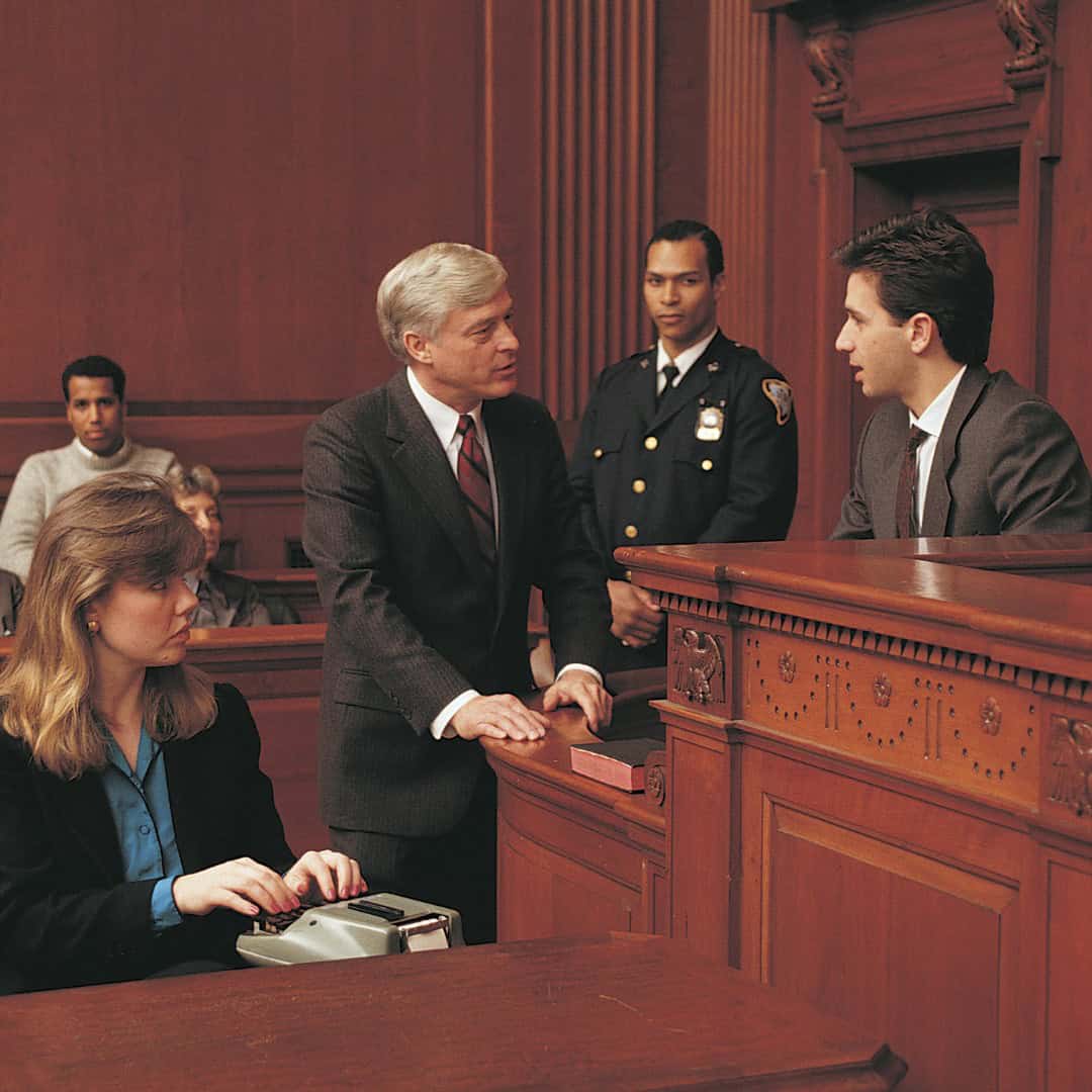 Massachusetts legal services - A courtroom scene with a lawyer, judge, and defendant during a legal proceeding in Massachusetts.
