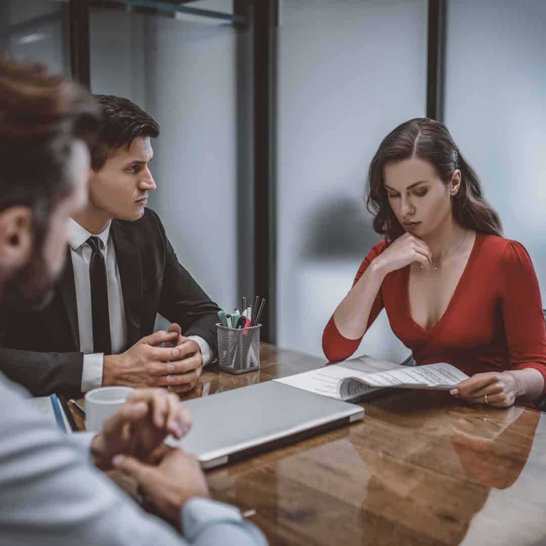 Massachusetts legal services - A woman consulting with a lawyer in an office setting, discussing legal matters.