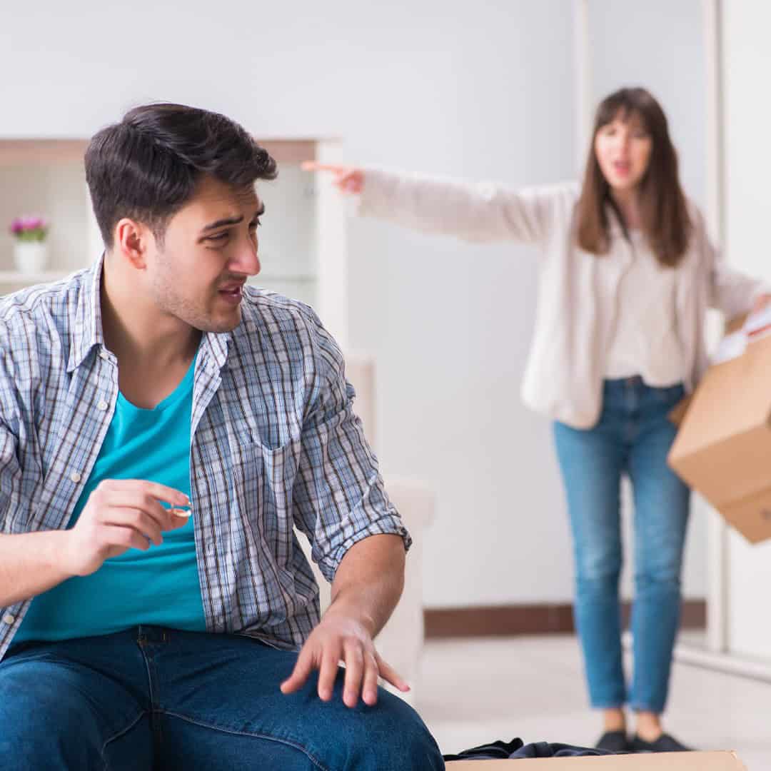 Massachusetts legal services - A man appears upset during a legal dispute while a woman in the background points and holds a box.