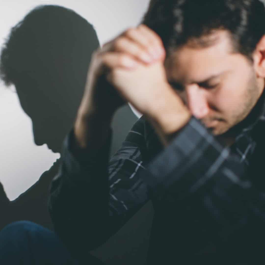Resources 12 Massachusetts legal services - A man in distress with shadow of a lawyer in the background, legal support concept.