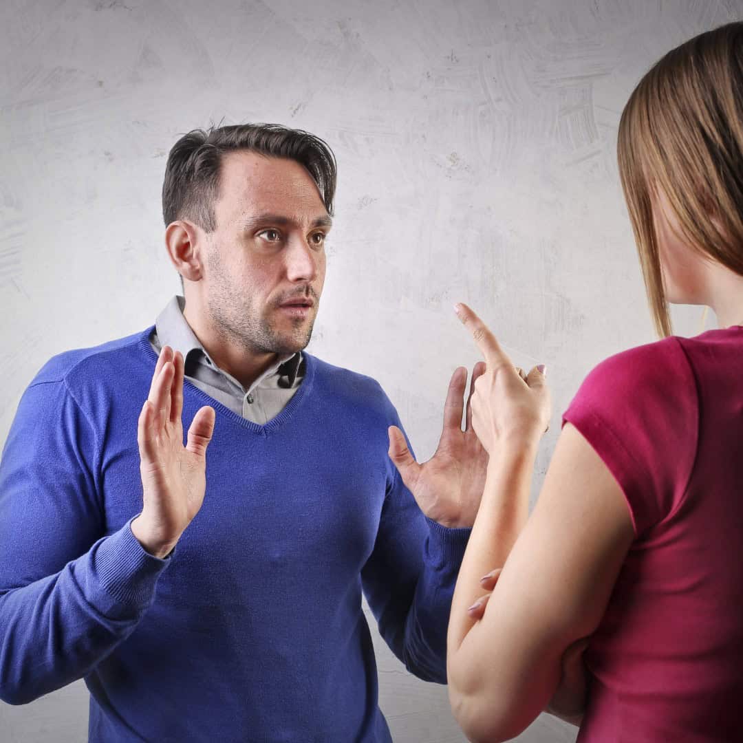 Massachusetts legal services - In a legal dispute, a man and woman argue with gestures in a Massachusetts office setting.