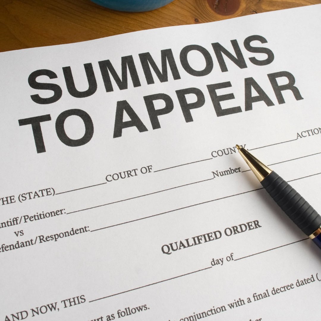 Massachusetts legal services - Summons to appear document with legal court details and a pen on top.