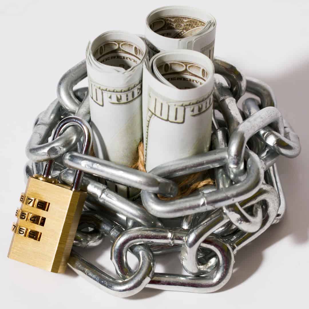 Resources 10 Massachusetts legal services - Rolled dollar bills secured with chains and a padlock, symbolizing financial restrictions or legal c.
