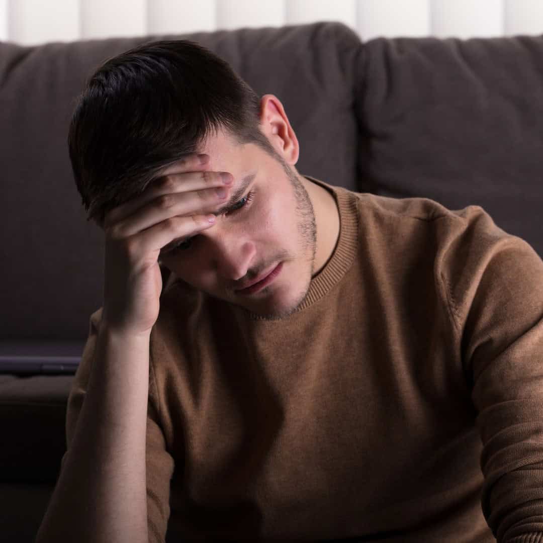 Resources 4 Massachusetts legal services - A young man with a distressed expression holding his head, possibly experiencing legal stress or con.