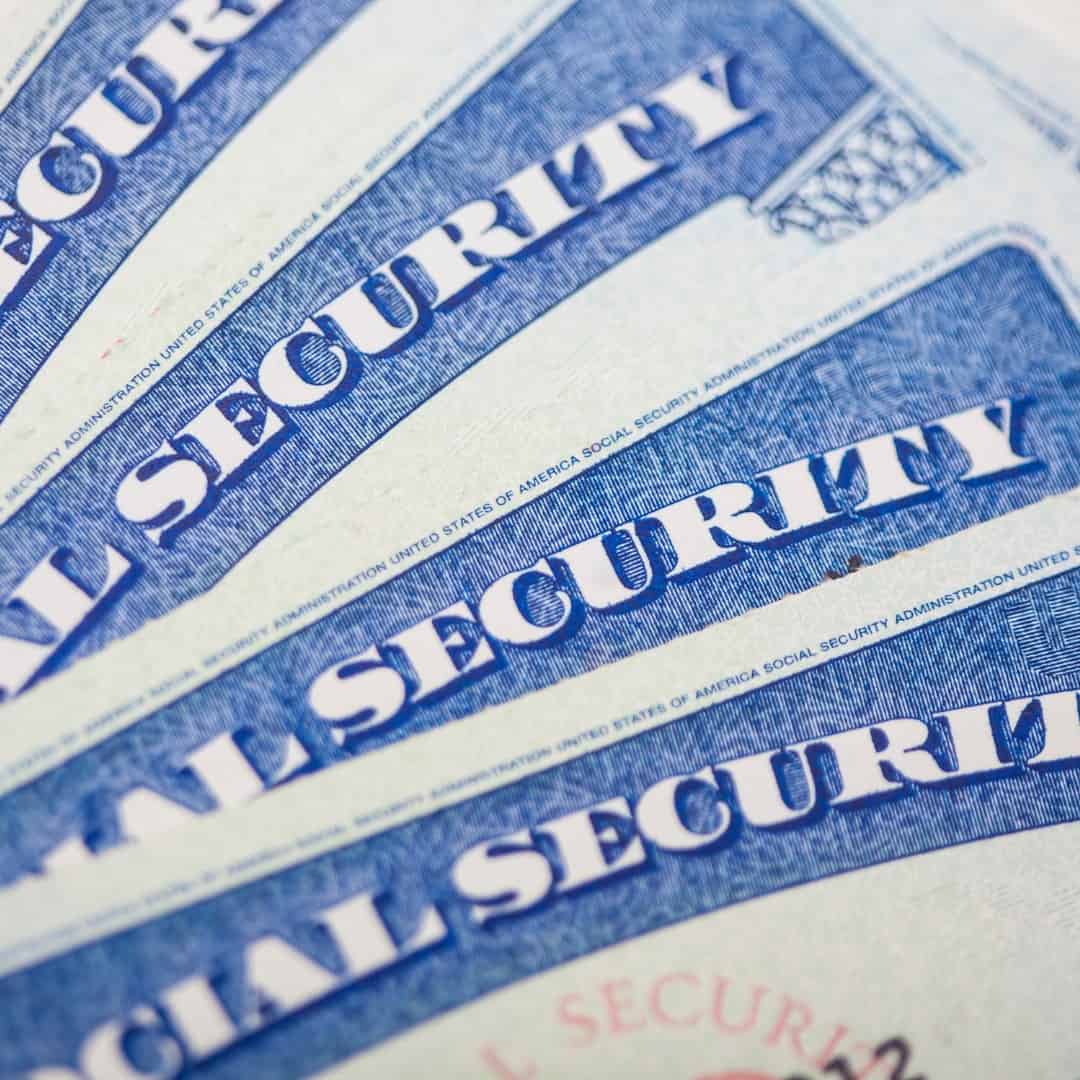 Resources 8 Massachusetts legal services - Close-up of multiple U.S. Social Security cards, legal identification documents.