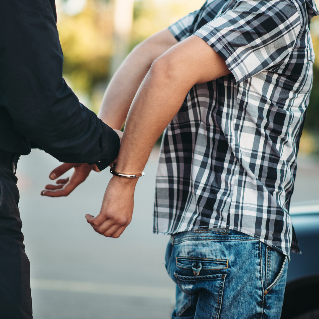 Cop arresting man for violating a restraining order in Massachusetts.