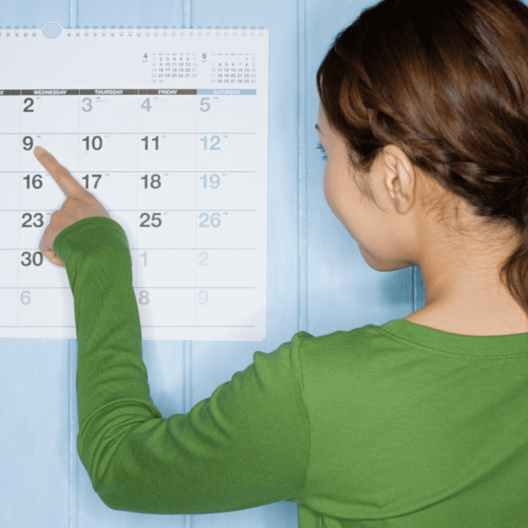 Woman looking at calendar in Massachusetts.