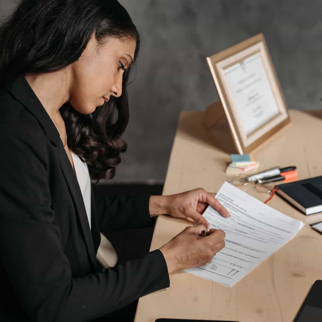 Woman signing Massachusetts restraining order application.