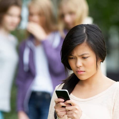 Woman reading harassing text messages in Massachusetts.