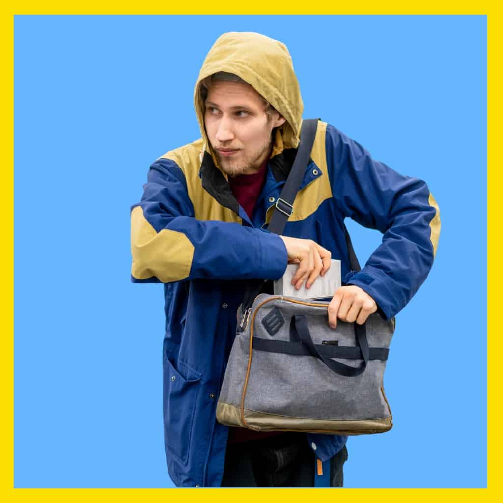 Man concealing merchandise in his bag.